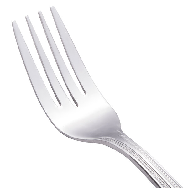 A close-up of a Walco stainless steel salad fork with a silver handle.