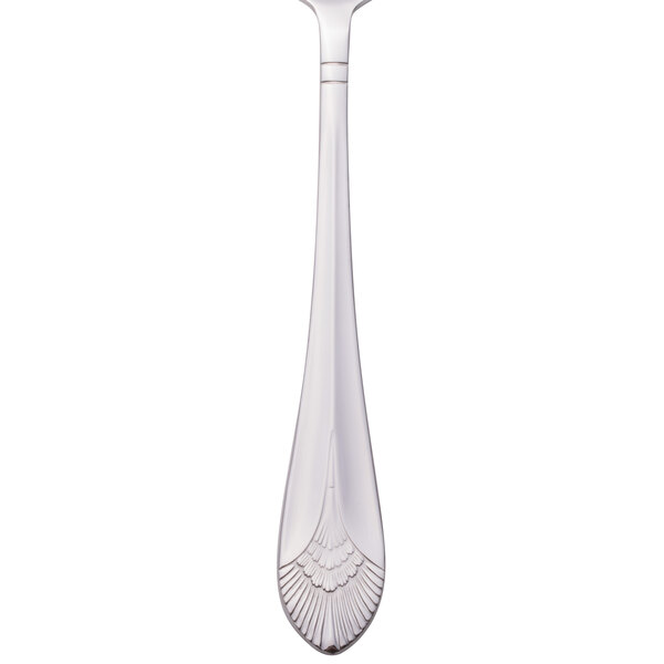A silver Walco Meteor serving spoon with a handle decorated with a design.