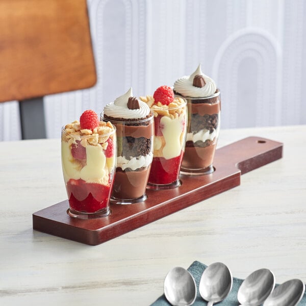 An Acopa mahogany flight paddle with Barbary tasting glasses holding desserts.