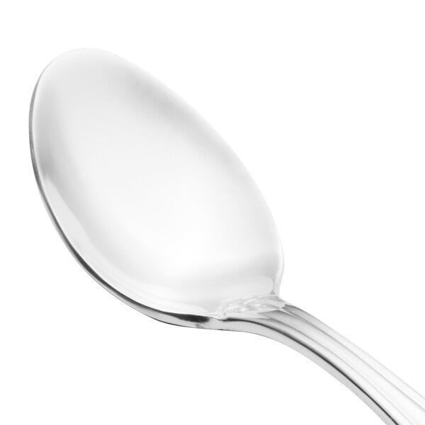 A close-up of a Walco stainless steel teaspoon with a silver handle.