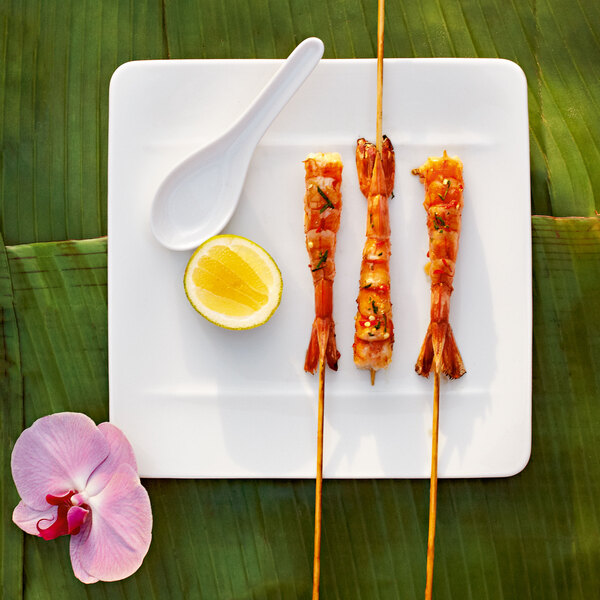 Grilled shrimp skewers on a Villeroy & Boch white bone porcelain square plate.