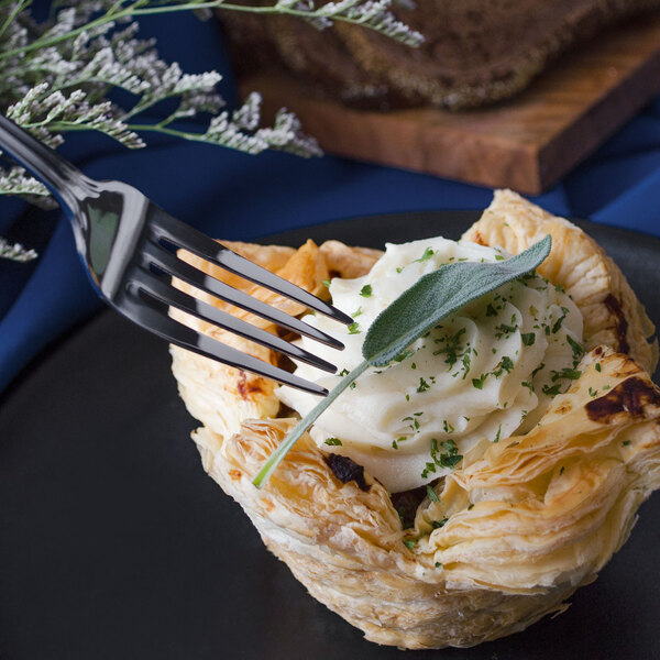A Walco Marcie stainless steel dinner fork in a pastry.