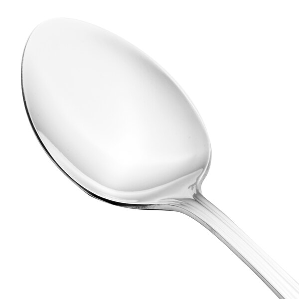 A close-up of a Walco stainless steel serving spoon with a white handle.