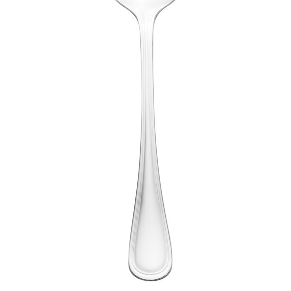 A close-up of a Walco stainless steel serving spoon.
