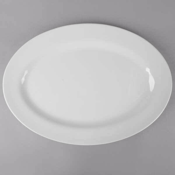 A white Thunder Group oval melamine platter with a white rim on a gray surface.