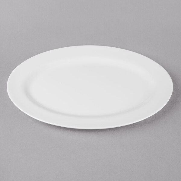 A white Thunder Group oval melamine platter with a white rim on a gray surface.