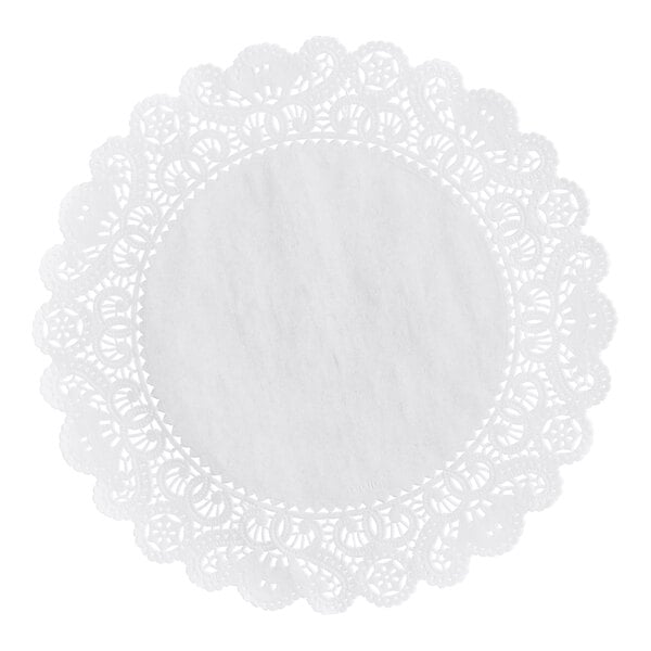 A round white paper doily with an intricate lace-like pattern around the edges.