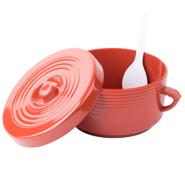 A red container with a lid and a white spoon inside.