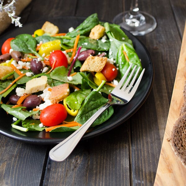 A plate of salad with a Walco Marcie salad fork.