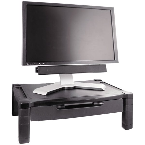 A computer monitor on a Kantek adjustable monitor stand with a keyboard on a table.