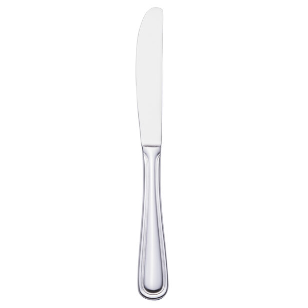 A Walco stainless steel dinner knife with a white handle and silver blade.