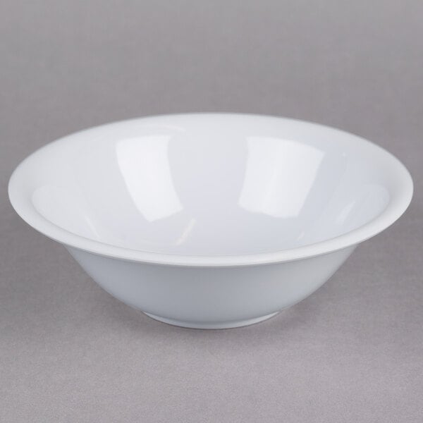 A white Thunder Group Imperial melamine bowl with a white rim on a gray surface.