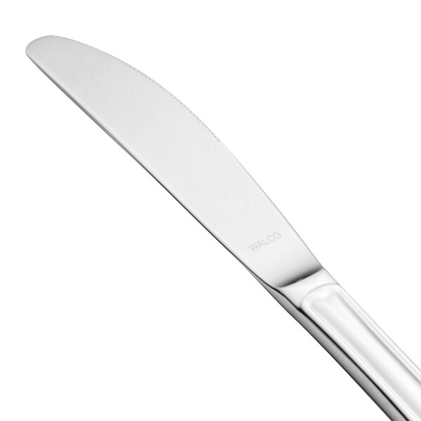 A close-up of a Walco Barony stainless steel dinner knife with a silver handle.