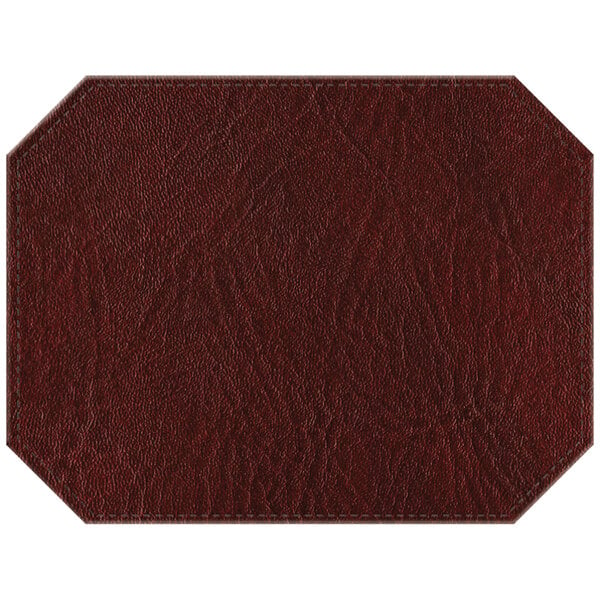 A brown faux leather octagon placemat with stitching.