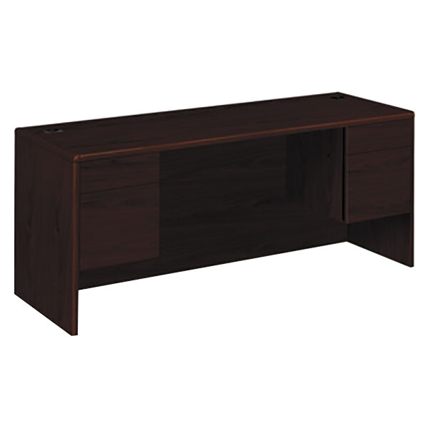 A dark wood HON pedestal credenza with a drawer.