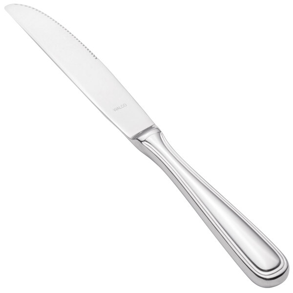 A close-up of a Walco stainless steel dinner knife with a silver handle.