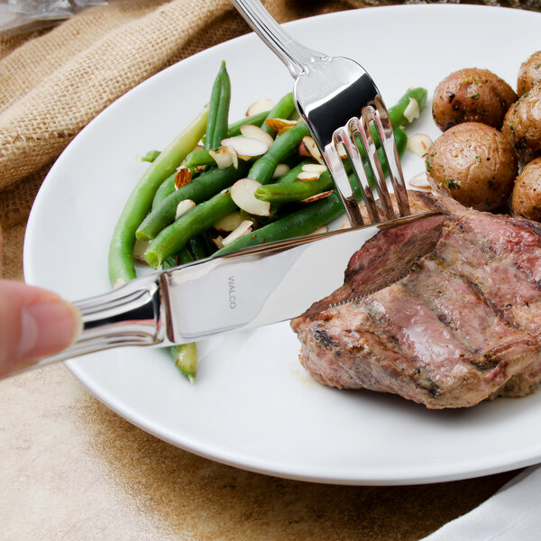 A plate of food with a Walco Ultra stainless steel dinner knife and fork.