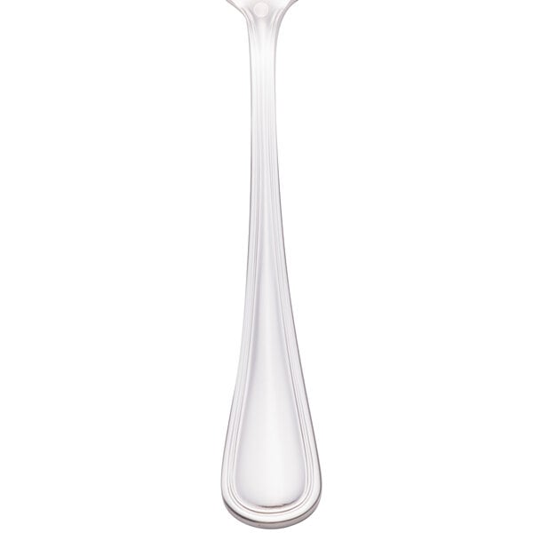 A close-up of a Walco stainless steel teaspoon with a white background.