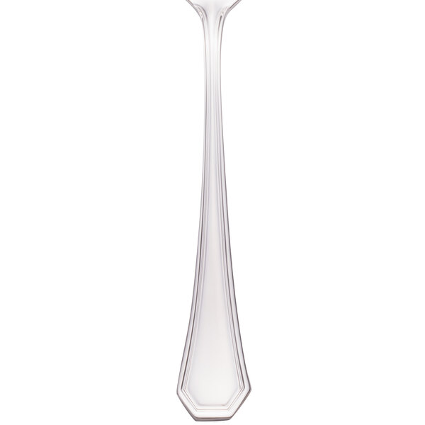 A close-up of a Walco stainless steel table fork with a white background.