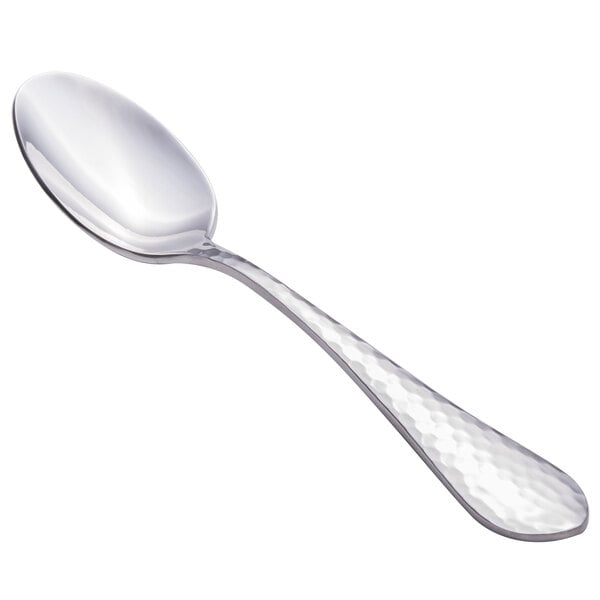 A close-up of a Walco stainless steel spoon with a textured silver handle.