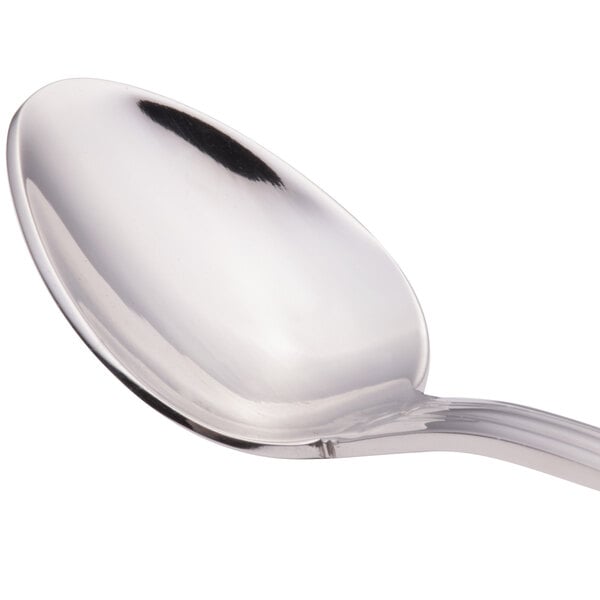 A close-up of a Walco stainless steel iced tea spoon with a silver handle.