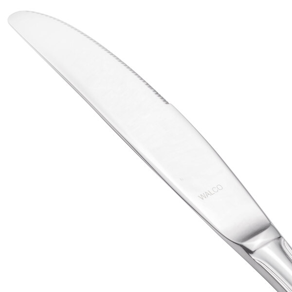 A close-up of a Walco stainless steel dinner knife with a silver handle.