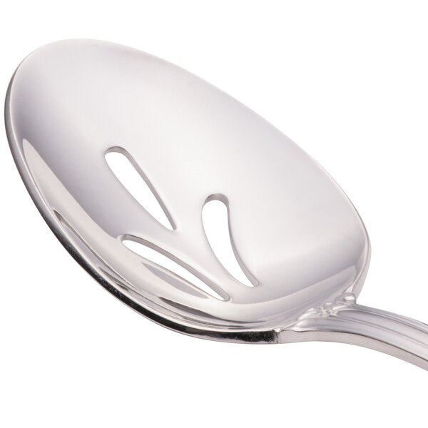 A Walco stainless steel serving spoon with a pierced handle.