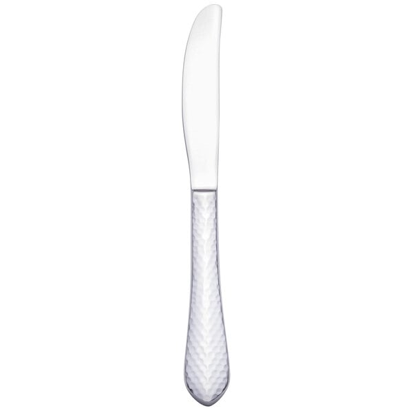 A Walco stainless steel European dinner knife with a white handle.