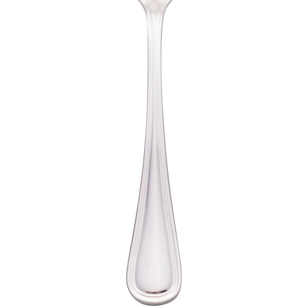 A Walco stainless steel bouillon spoon with a white handle.