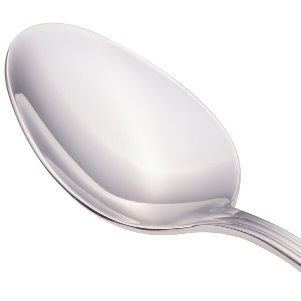 A Walco stainless steel dessert spoon with a silver handle.