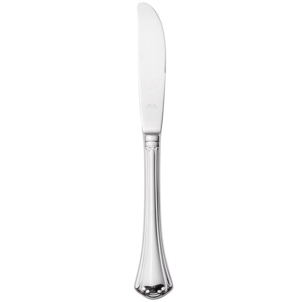 A silver Walco stainless steel table knife with a white hollow handle.