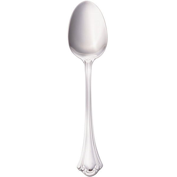 A close-up of a Walco stainless steel serving spoon with a white handle.