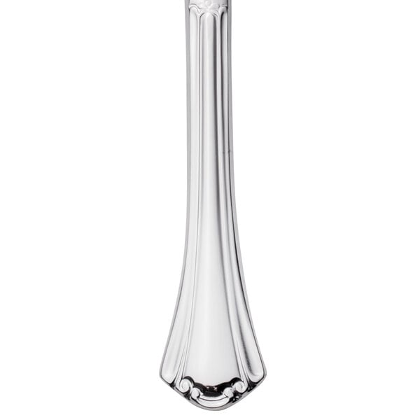 A Walco stainless steel steak knife with a solid handle.