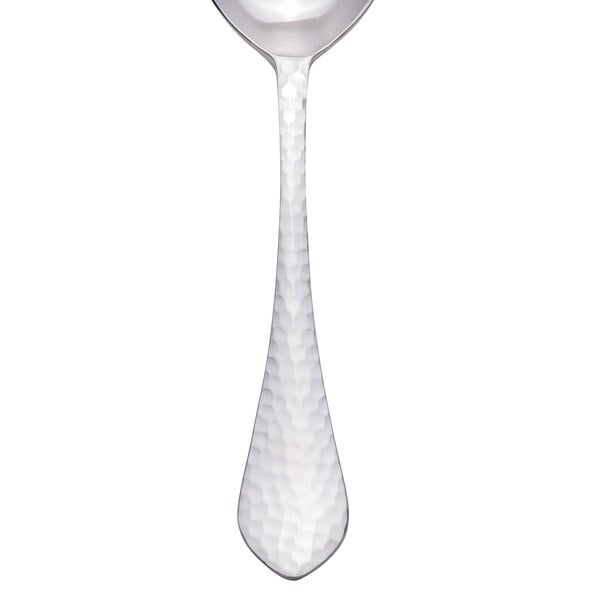 A silver spoon with a textured white handle.
