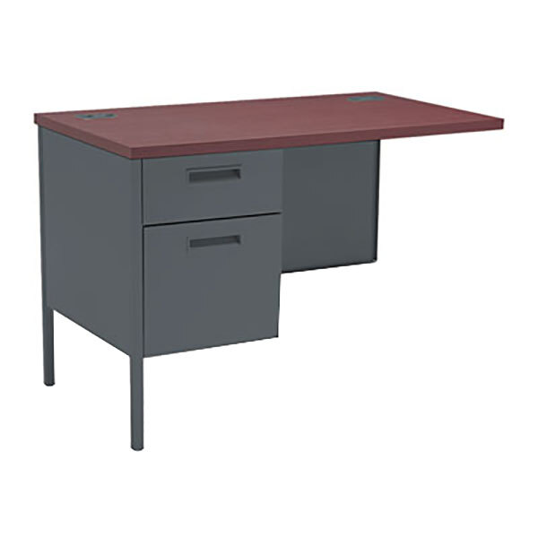 A mahogany desk with a grey top and grey drawer with a handle.