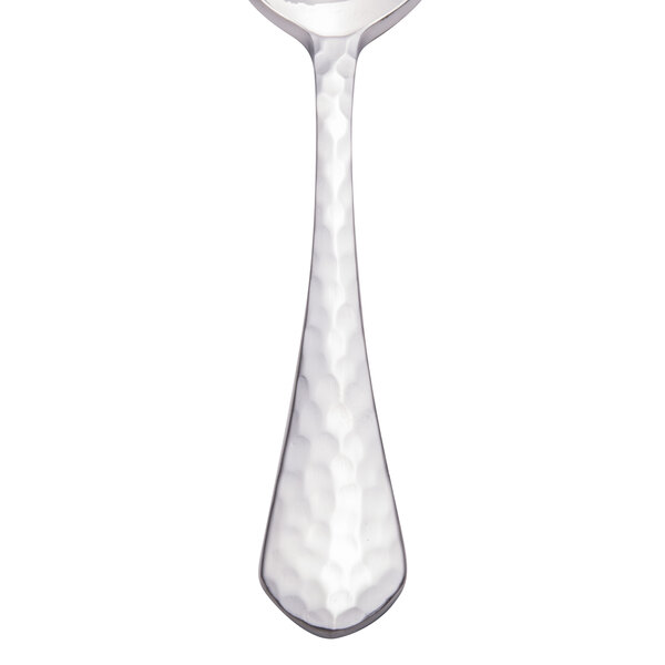 A Walco stainless steel demitasse spoon with a textured handle.