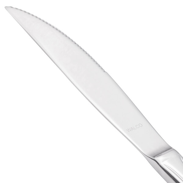 A Walco Prim stainless steel steak knife with a solid handle.