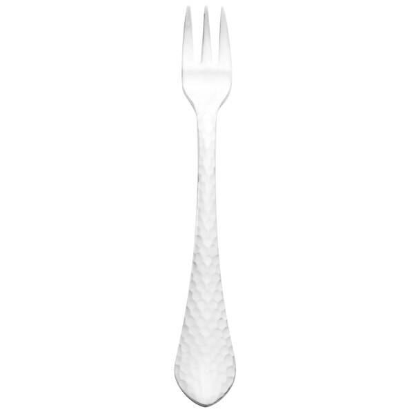 A silver cocktail fork with a white handle.