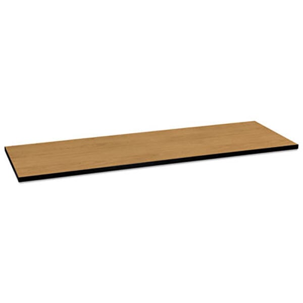 A rectangular wooden HON table top with a black edge and a brown surface.