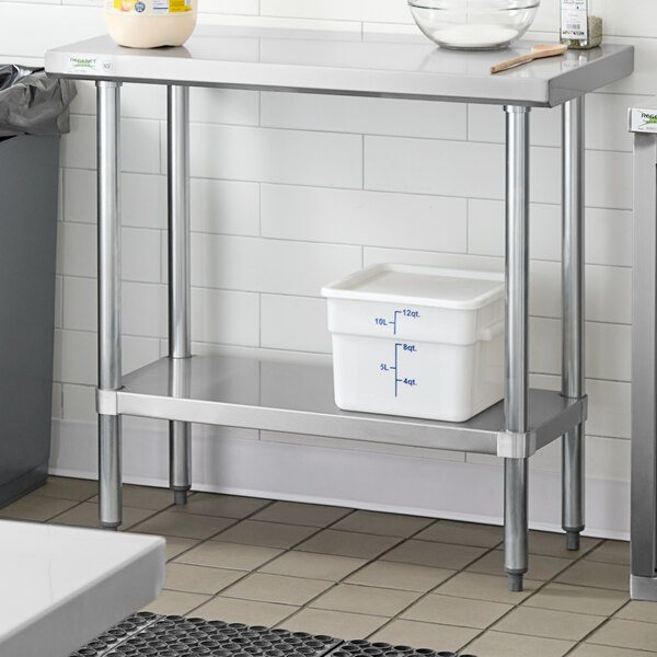 A metal Regency adjustable undershelf on a stainless steel work table with a white plastic container on it.