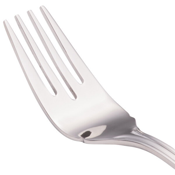 A close-up of a Walco stainless steel fish fork with a flat handle.
