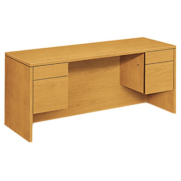 A wooden HON 10500 Series pedestal credenza with drawers and a cabinet.