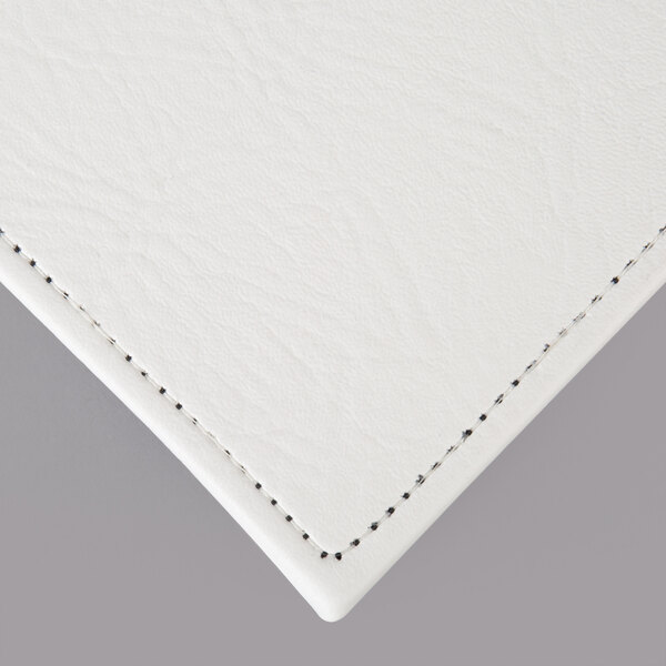 A close up of a customizable white hardboard placemat with a small amount of texture.
