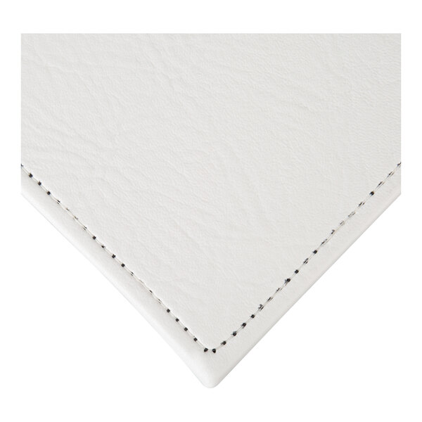 A white rectangular hardboard and faux leather placemat with visible stitching along the edge.