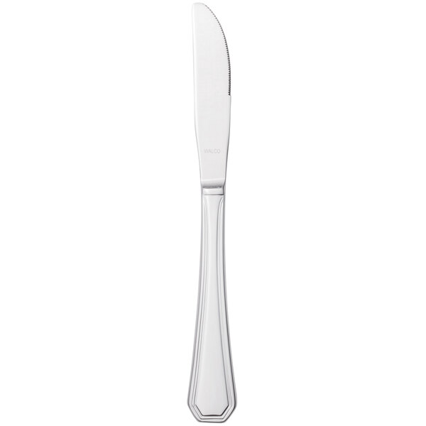 A silver Walco Prim stainless steel dinner knife with a white background.