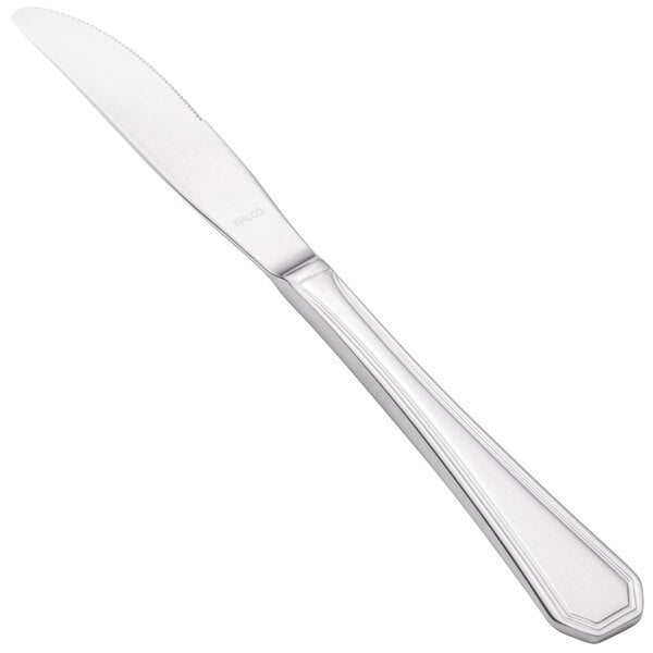 A close-up of a Walco stainless steel dinner knife with a white handle.