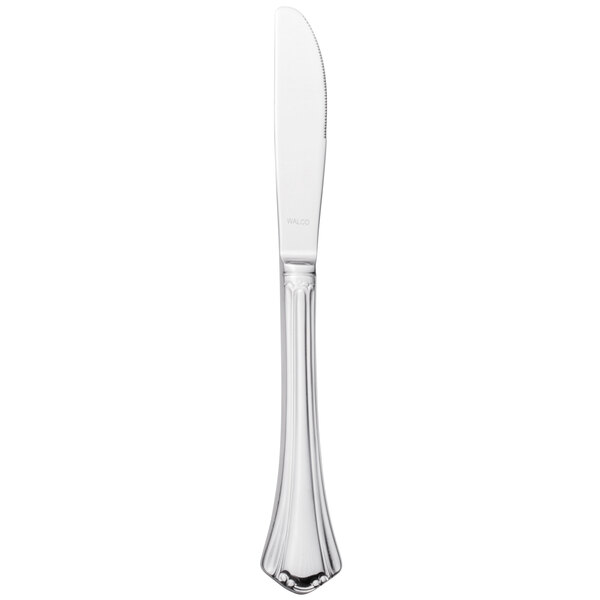A silver Walco stainless steel dinner knife with a white background.