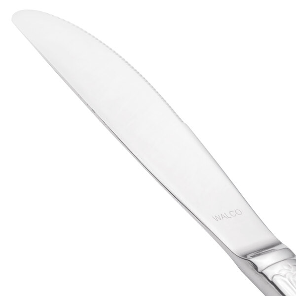 A close-up of a Walco stainless steel dinner knife with a silver handle.