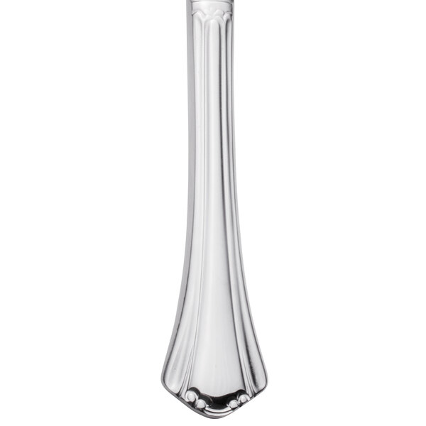 A Walco stainless steel dinner knife with a white handle.