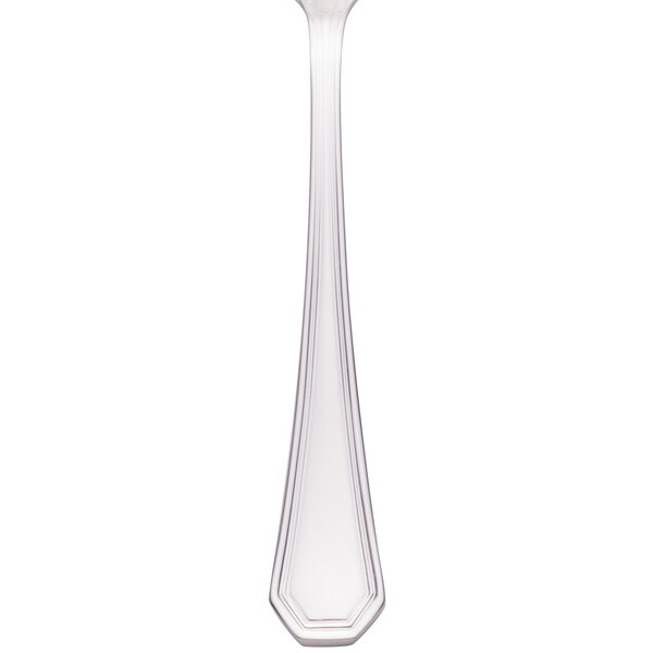 A Walco stainless steel teaspoon with a white handle and silver spoon.
